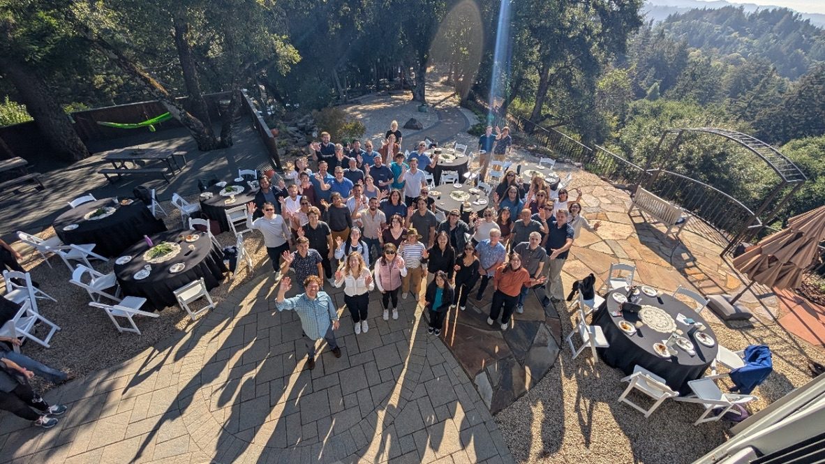 A large group gathered on the redwood deck